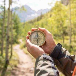 Hands holding a compass for Acceptance and Commitment Therapy